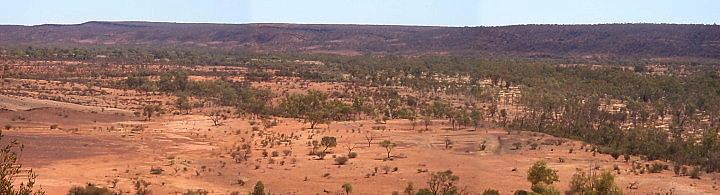 Panorama of red desert country under a pale sky
