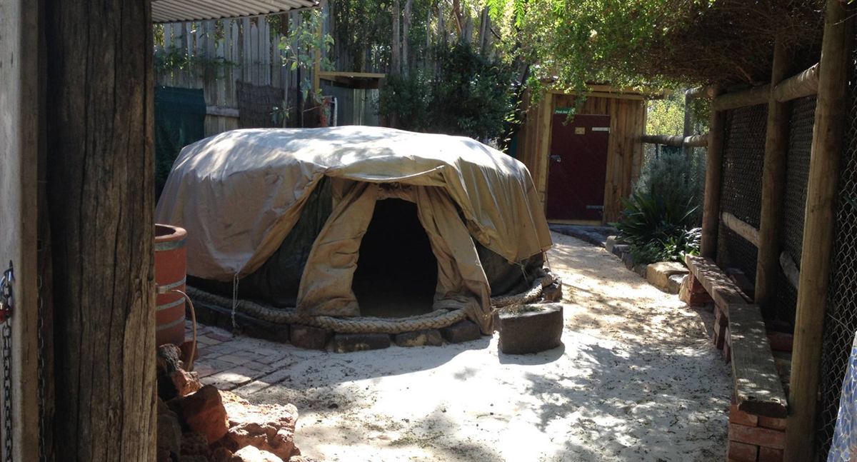 The SOTEMS sweat lodge in Melbourne, covered in canvas, with its low doorway